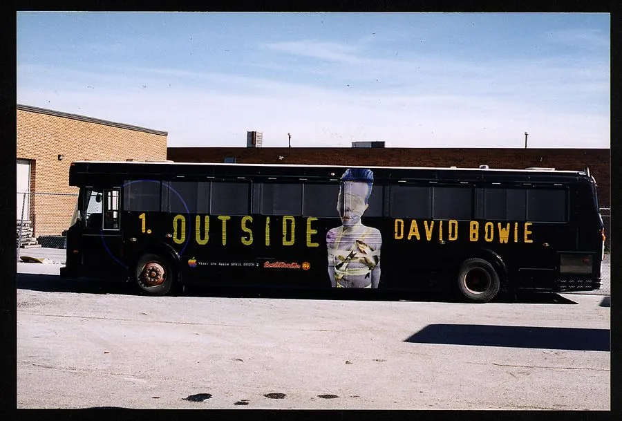 A full 1.Outside bus wrap, photographed in 1995 — small print by the front wheel: “Visit the Apple BOWIE BOOTH”